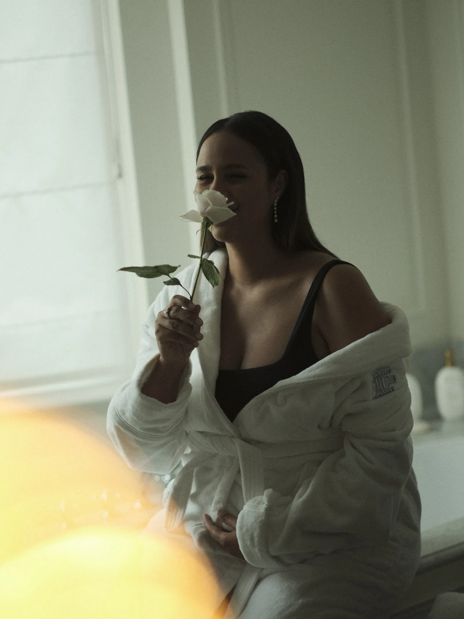 Image may contain Zawe Ashton Face Head Person Photography Portrait Adult Flower Plant Body Part Finger and Hand
