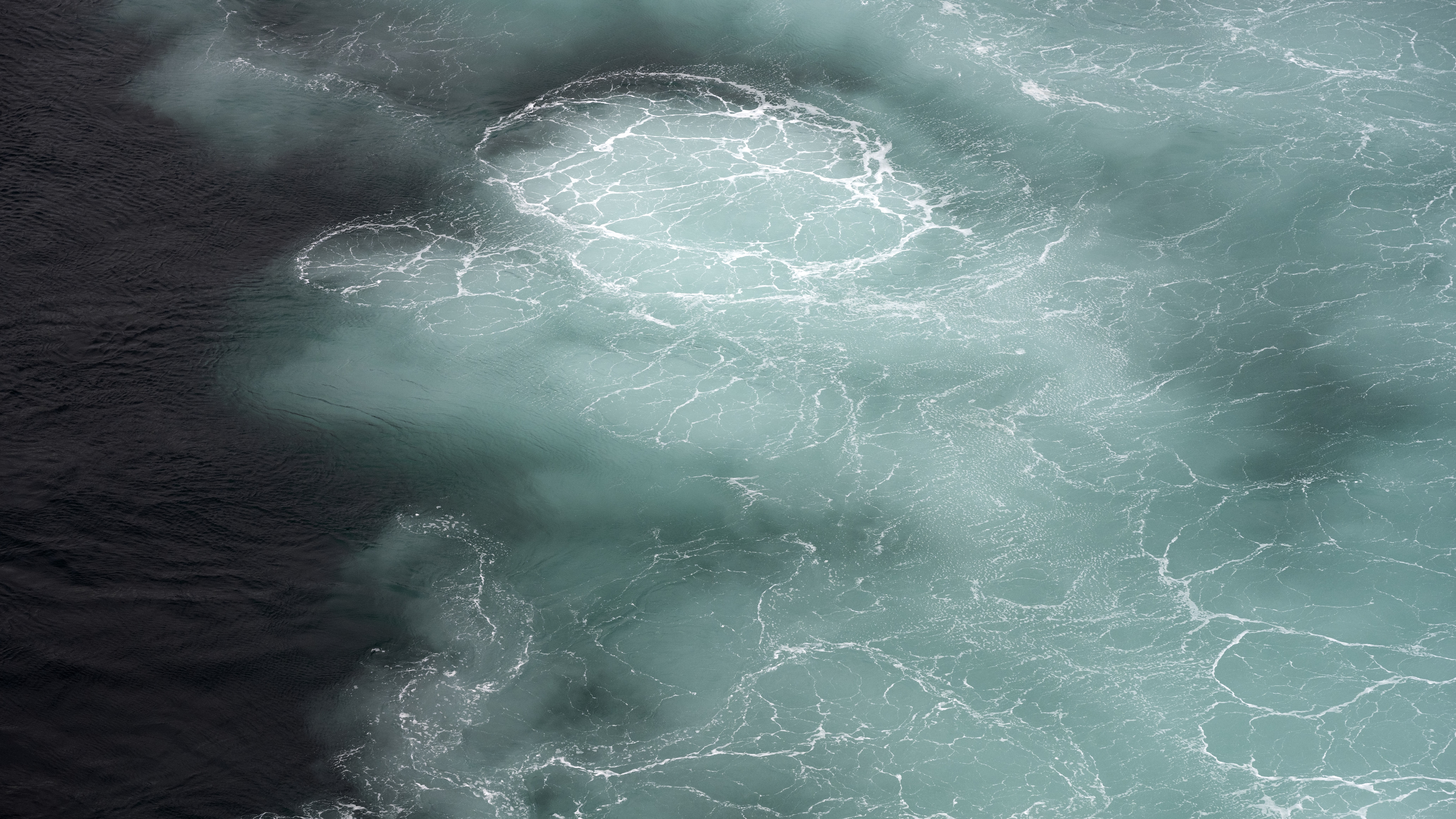 A photo of water churning off the coast of Streymoy in the Faroe Islands.