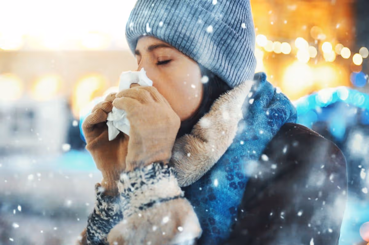 Woman with a cold in the snow