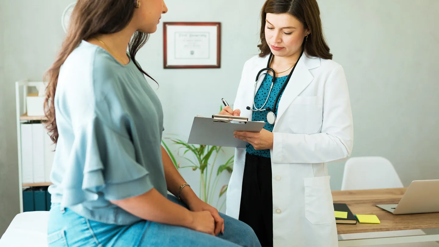 unrecognizable woman talking to her doctor about vaginal health