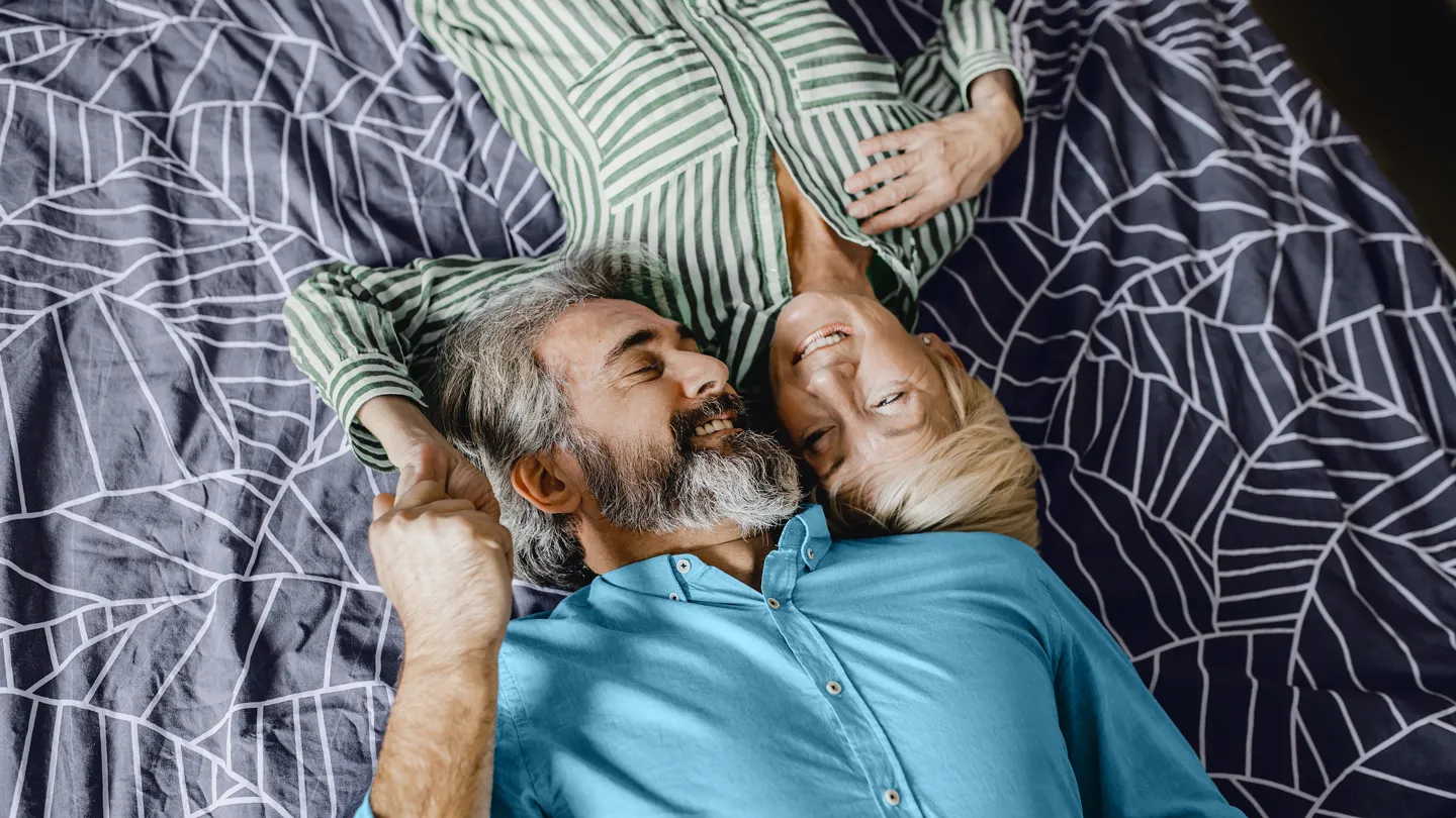 mature couple being romantic in bed