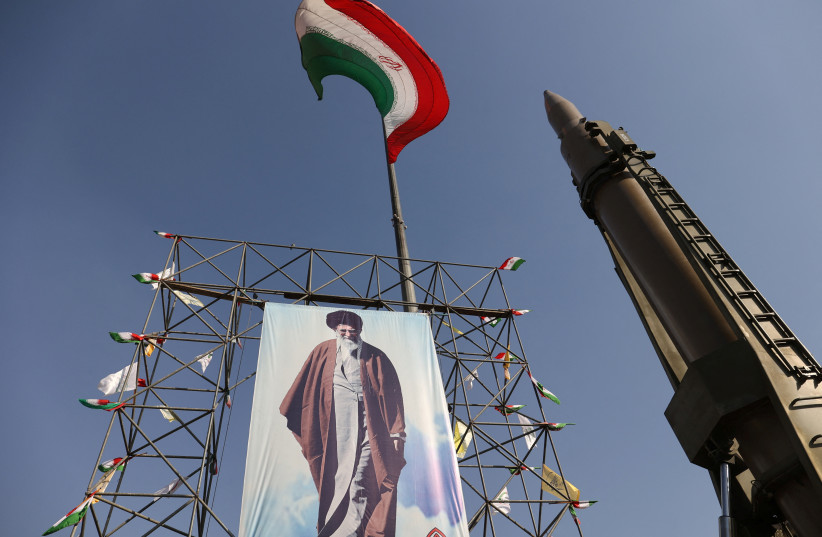 An Iranian missile system is displayed next to a banner with a picture of Iran's Supreme Leader Ayatollah Ali Khamenei, during Iranian defence week, in a street in Tehran, Iran, September 24, 2024. (credit: MAJID ASGARIPOUR/WANA