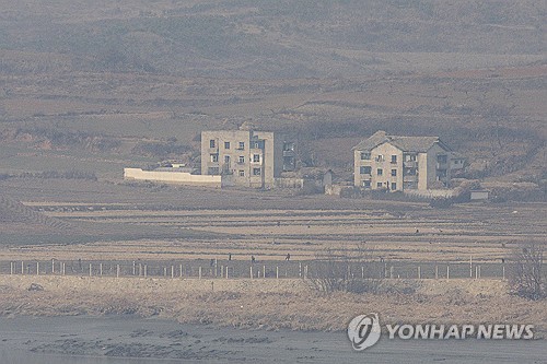 This file photo, taken from the border city of Paju, 28 kilometers northwest of Seoul on Dec. 11, 2024, shows buildings in a border area in North Korea. (Yonhap)